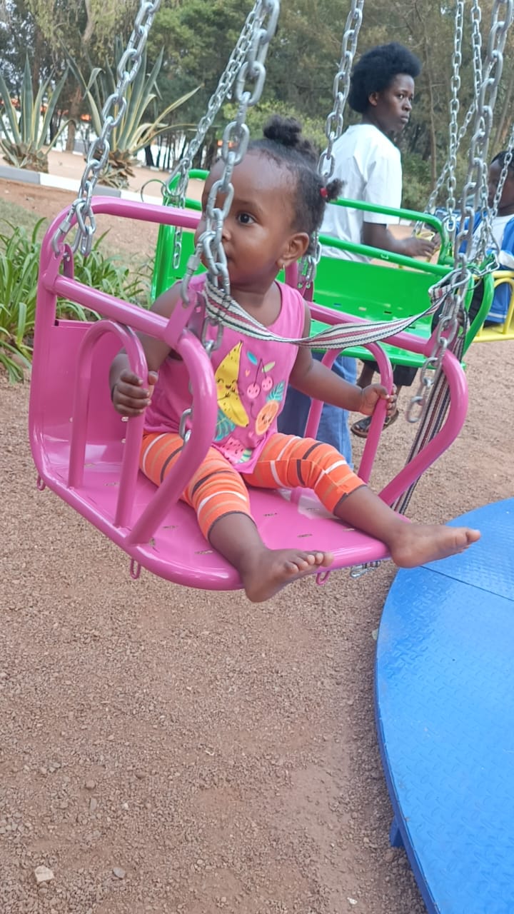 Child enjoying a swing ride at the park