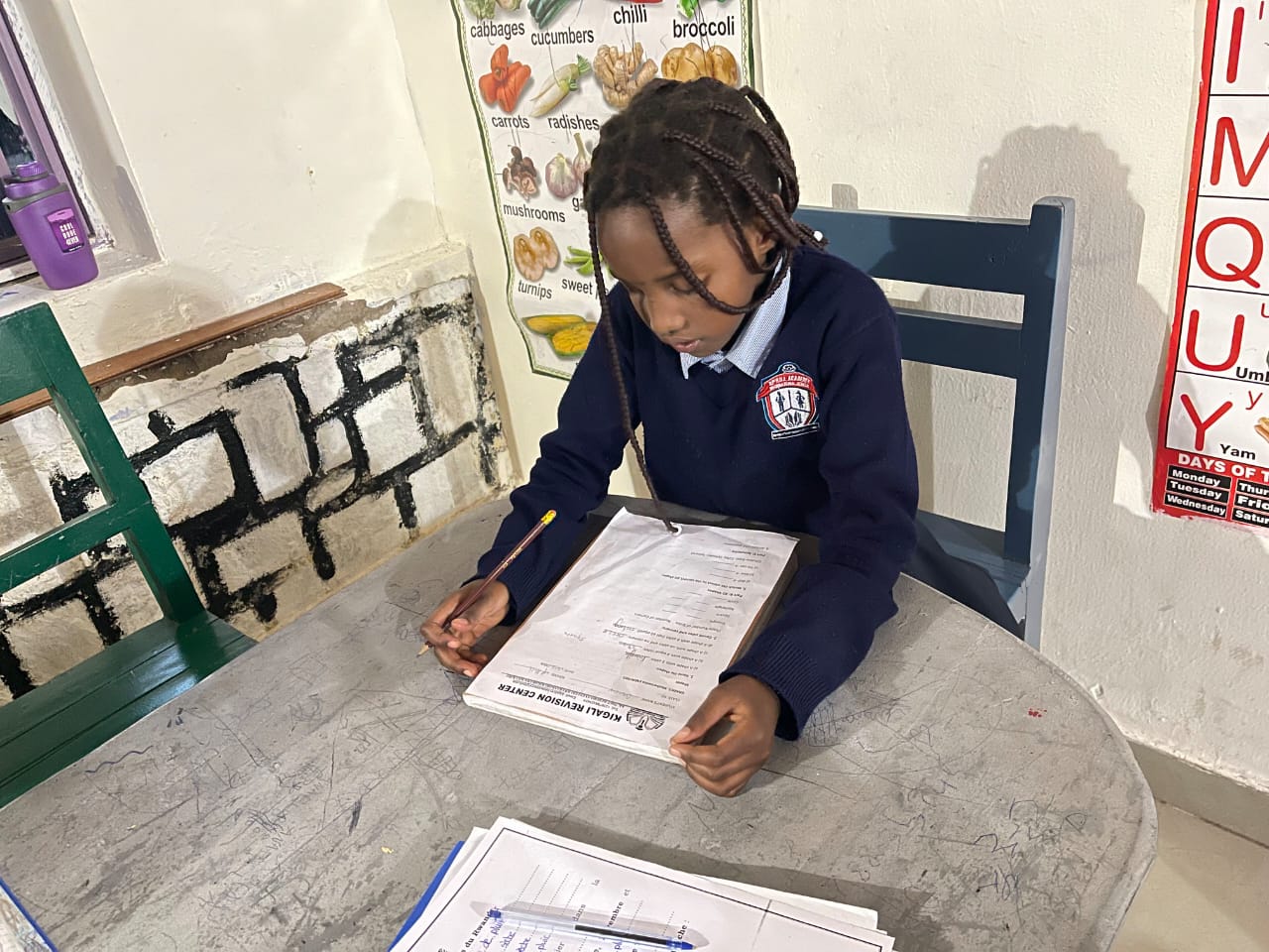 A student studying with Kigali Revision Center materials